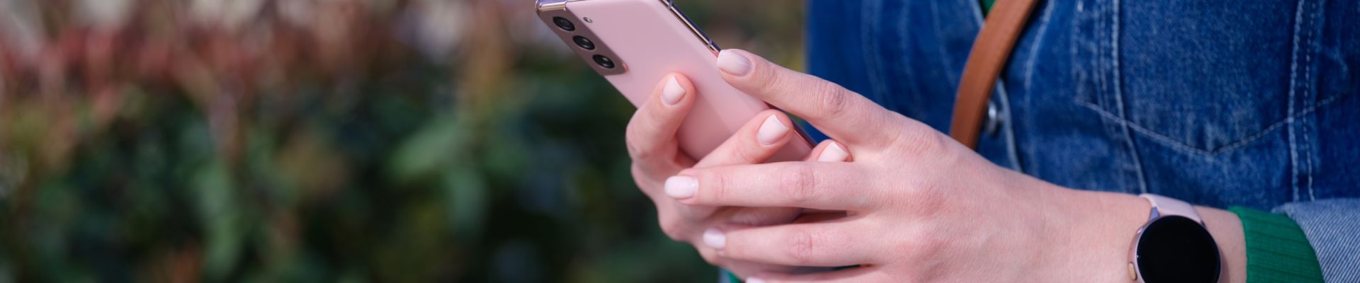 woman-sitting-park-holding-mobile-phone-her-hands-closeup-remote-communication